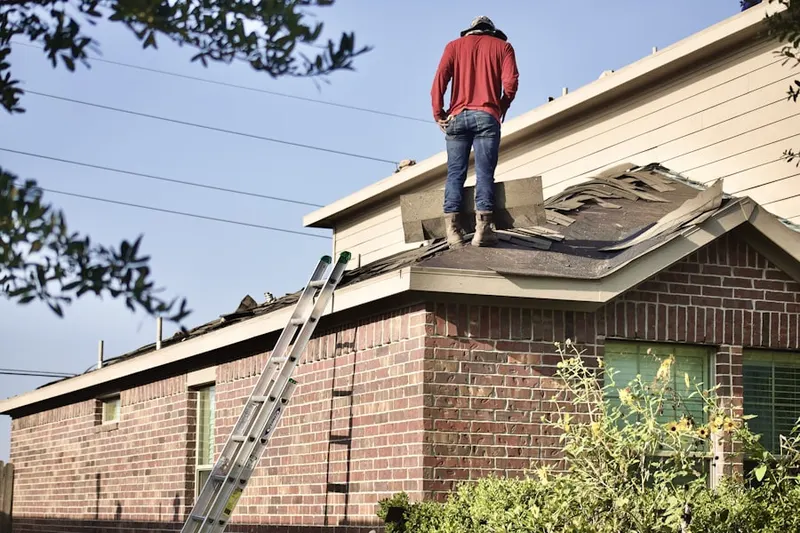Professional roofer working on a residential roof in South Poly